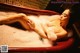 A naked woman laying in a bathtub filled with foam.